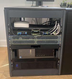 A closeup of the server rack, filled with various servers, networking devices, and ethernet cables running